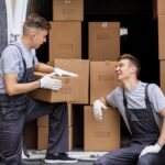 Local NJ movers loading moving boxes into a van in Jersey City.